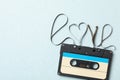 Top view of music cassette and word Love made with tape on turquoise background, space for text. Romantic songs