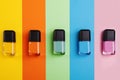 Top view of nail polish bottles in different shades on a colorful surface Royalty Free Stock Photo