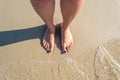 The foot is on the wet sea sand Royalty Free Stock Photo