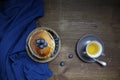 Top view of national dish pancakes, pancakes, pita with blueberries, linen napkin, poured with honey, concept of traditional