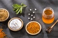 Top view of natural sweeteners - Sugar, stevia leaves, pollen and honey