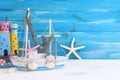 Top view of Nautical concept with sea life style objects as boat, driftwood beach houses, seashells and starfish over wooden Royalty Free Stock Photo