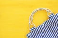 Top view of nautical summer/beach bag on yellow wooden background Royalty Free Stock Photo