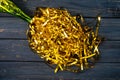 Top view of the neck of a green champagne bottle with a splash of golden tinsel splash. Golden shiny serpentine ribbons Royalty Free Stock Photo