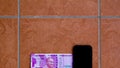 Top view of the new Rs 2000 currency bill kept alongside a smartphone. The new bill was introduced in India after demonetization