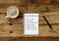 New Year Resolutions written on notebook with pen coffee on vintage wood table in Better life goals Royalty Free Stock Photo