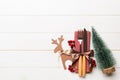 Top view of new year utensils on napkin with holiday decorations and reindeer on wooden background. Christmas dinner concept with Royalty Free Stock Photo