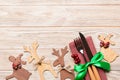 Top view of new year utensils on napkin with holiday decorations and reindeer on wooden background. Christmas dinner concept with Royalty Free Stock Photo