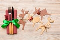 Top view of new year utensils on napkin with holiday decorations and reindeer on wooden background. Close up of christmas dinner Royalty Free Stock Photo