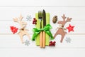 Top view of new year utensils on napkin with holiday decorations and reindeer on wooden background. Close up of christmas dinner Royalty Free Stock Photo