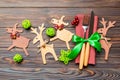 Top view of new year utensils on napkin with holiday decorations and reindeer on wooden background. Close up of christmas dinner Royalty Free Stock Photo