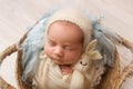 Top view of a newborn baby girl sleeping in a white cape with a blue bandage Royalty Free Stock Photo