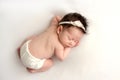 Top view of a newborn baby girl sleeping in white panties, with a white bandage Royalty Free Stock Photo