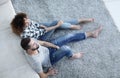 Newlywed couple sitting on a carpet in a new living room Royalty Free Stock Photo