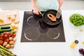 Top view of nice skilled girl cooking fresh homemade meal cuisine enjoying ocean food at home light white kitchen Royalty Free Stock Photo