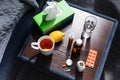 View of nightstand with cup, glass of water, lemon, napkins and medicine Royalty Free Stock Photo