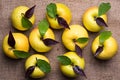 Top view of nine yellow apples with water drops and leaves on br