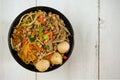 Top view noodle with minced pork , meatballs, dried shrimps and vegetables in black bowl
