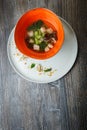 Top view noodle soup with mushrooms, meat, and nettle leaves