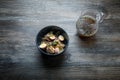 top view noodles dish with shiitake mushrooms, eggs, wheat sprouts and pitcher with broth