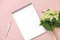 Top view note book and flowers on the desktop. For wedding planner concept