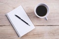 Top view Note book with pen and a cup of coffee on wood table for Business