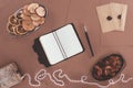 top view of notebook, jewelry box, dried fruits and envelopes over brown