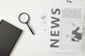 top view of notebook, magnifying glass and newspapers isolated on grey