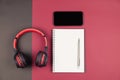 Top view of notebook with pen smartphone and headphone Royalty Free Stock Photo