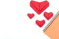 Top view Notebook,Red heart folded with paper origami hearts showing love for Valentine`s Day Isolated on White Background There Royalty Free Stock Photo