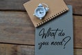 Notebook written with question WHAT DO YOU NEED Royalty Free Stock Photo