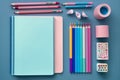 Top view of notebooks, pens, color pencils, marker and watercolor School stationery