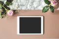 Top view on notepad with mockup on pastel background with pink roses