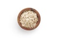 A top view of oat flakes in a wood bowl on white background Royalty Free Stock Photo