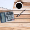 Top view Office desk with calculator, pen, blank notebook and coffee cup on wood table background. workspace or home office with Royalty Free Stock Photo