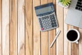 Top view Office desk with calculator, pen, computer laptop, plant pot and coffee cup on wood table background. workspace or home Royalty Free Stock Photo
