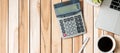 Top view Office desk with calculator, pen, computer laptop, plant pot and coffee cup on wood table background. workspace or home Royalty Free Stock Photo