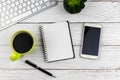 Top view of office desk with note pad, smartphone and computer keyboard Royalty Free Stock Photo