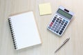 Top view of office desk with notebook, calculator, pen and note Royalty Free Stock Photo