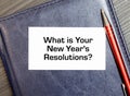 Top View Of Office Desk and Notepad With Text - What is Your New Year's Resolutions Royalty Free Stock Photo