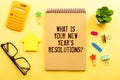 Top View Of Office Desk and Notepad With Text - What is Your New Year's Resolutions Royalty Free Stock Photo