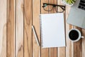Top view Office desk with pen, computer laptop, blank notebook, plant pot and coffee cup on wood table background. workspace or Royalty Free Stock Photo