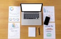 Top view of office desk table with laptop, mobile phone, document chart, pencil, empty paper. Top view laptop with empty white