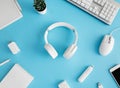 Top view of office desk table with notebook, plastic plant, smartphone and keyboard on blue table background, graphic designer, Cr Royalty Free Stock Photo