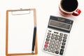 The top view of the office desk on white backgroundblank paper, pen, calculator,glasses, coffee. Financial planning and work