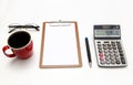 The top view of the office desk on white backgroundblank paper, pen, calculator,glasses, coffee. Financial planning and work