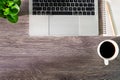 Top view of Office desk wooden table with laptop notebook, pencil and white cup of black coffee. Royalty Free Stock Photo