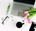 top view office feminine desk and bouquet pink tulips