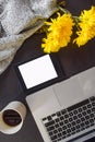 Top view of an office mock up with a laptop, notebook and pen, cup of coffee, cardigan sweater Royalty Free Stock Photo