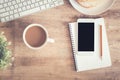 Top view of office table . On desk have notebook coffee cup laptop smartphone and pencil